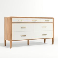 a white and wood dresser with gold handles on it's legs, against a white background