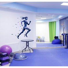 an exercise room with blue carpet and white walls