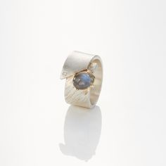 Silver & Stone Ring - On a luxe sterling silver ring, a mesmerizinglabradorite gem shimmers from a 14k goldprong setting, while a 0.03ct diamond accentsparkles below. <br><br>Available in whole, half, andquarter sizes 5-11. Luxury Sterling Silver Moonstone Ring For Anniversary, Luxury Silver Diamond Moonstone Ring, Modern Silver Topaz Ring With Gemstone Accents, Elegant Labradorite Gemstone Ring, Anniversary Moonstone Ring With Diamond And Gemstone Accents, Elegant Labradorite Open Ring, Anniversary Silver Moonstone Ring With Diamond Accents, Silver Moonstone Ring With Single Cut Diamonds, Elegant Labradorite Promise Ring