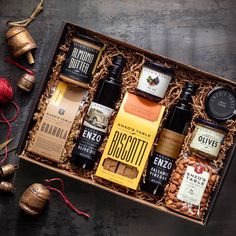 an assortment of liquors and nuts in a gift box with twine of twine