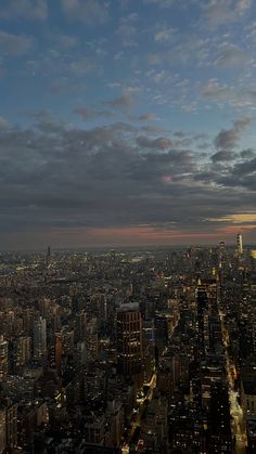 an aerial view of new york city at night from the top of the empire building