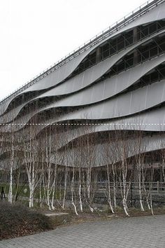 the building has many trees in front of it