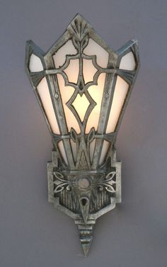 a wall light that has a glass shade on it