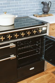 an oven with two burners and a pot on the stove top next to it