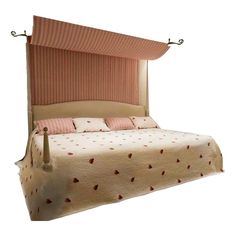 a bed with pink and white bedspread on it's headboard is shown