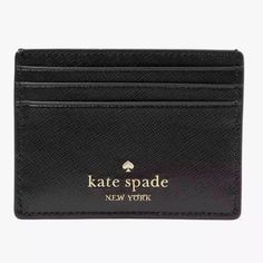 a black card case with the name kate spade new york written in gold on it