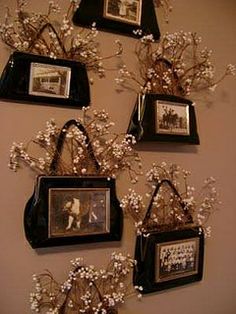 several framed pictures hang on the wall with baby's breath flowers in front of them