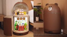 a bear shaped refrigerator with drinks in it