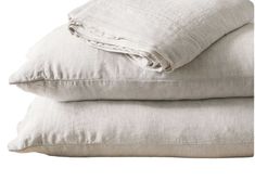 two linen pillows stacked on top of each other