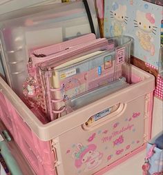 a pink toy chest with hello kitty items in it's storage compartment and other toys