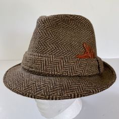 Hat has some wear and light fading. Band has cracking in material. See photos. Spring Brown Wool Hat, Winter Tweed Hat With Herringbone Pattern, Classic Fall Hat With Herringbone Pattern, Classic Outdoor Hat With Herringbone Pattern, Adjustable Brown Straw Hat For Fall, Classic Herringbone Pattern Hat For Outdoor, Classic Fall Herringbone Hat, Classic Hat With Herringbone Pattern And Curved Brim, Classic Hat With Curved Brim And Herringbone Pattern