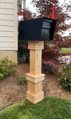 a wooden post with a mailbox attached to it