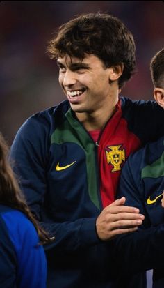 two soccer players are hugging each other on the field