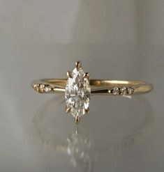 an engagement ring with a large diamond in the center and small diamonds on each side