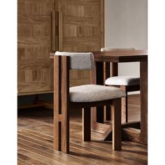 a wooden table with two chairs next to it on a hard wood flooring area