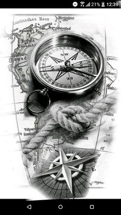 a black and white photo of a compass on top of a map with other items