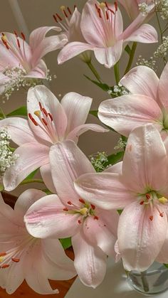 a vase filled with pink flowers on top of a table