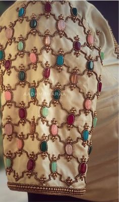 the back of a dress with beads on it