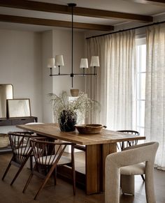 a dining room table with chairs and a bowl on it