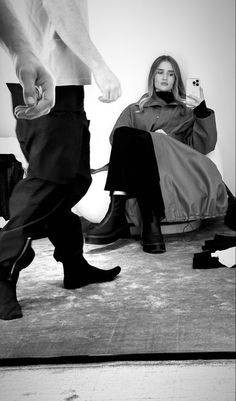 black and white photograph of two people sitting on the floor