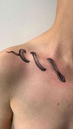 a man with a snake tattoo on his chest