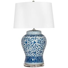 a blue and white table lamp with a white shade on the top, sitting in front of a white background