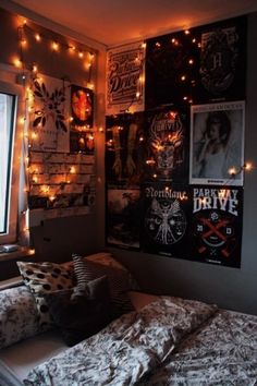 a bedroom with posters and lights on the wall