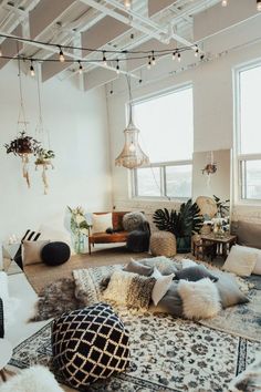 a living room filled with lots of furniture and decor on top of a white rug