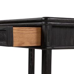 a close up of a wooden table with black metal legs and wood drawering on the top