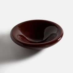 a brown bowl sitting on top of a white table