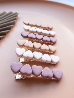 some heart shaped cookies are sitting on a plate