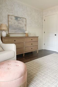 a baby's room with pink furniture and wallpaper