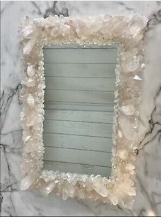 a white marble wall with a mirror on it