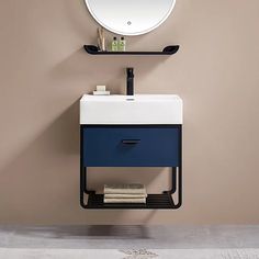 a bathroom with a sink, mirror and towel rack on the wall next to it