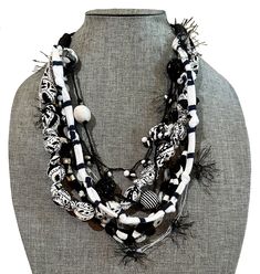 "Each one is handmade by textile designer Lynn Reiter Weinberg in her Ga. Studio using assorted black and white yarns, recycled fabrics, buttons, hand knotted fabric beads, crocheted threads and assorted handmade fiber and non-precious beads. There are a total of 7 strands all in black and white.  This light necklace is ideal for women who love the look of statement necklaces, but without the weight around their neck. Versatile and perfect for any season and any occasion. Looks great with a dres Fabric Necklaces, Black And White Necklace, Light Necklace, Recycled Necklaces, Fiber Necklace, Dress Business, Precious Beads, Fabric Necklace, Textile Designer