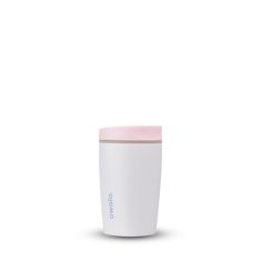 a white and pink coffee cup sitting on top of a table