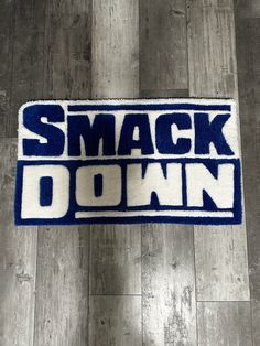 a blue and white rug with the words smack down on it