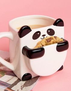 there is a panda bear mug with cookies in it