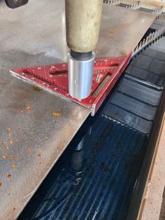 a machine that is cutting something on top of a metal table with it's tool