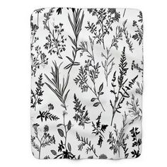 a black and white floral pattern on a sheet that has been made into a blanket