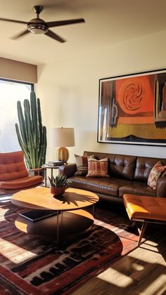 a living room filled with furniture and a large painting hanging on the wall above it