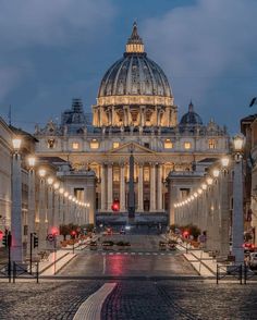 a large building with a dome in the middle of it's courtyard at night