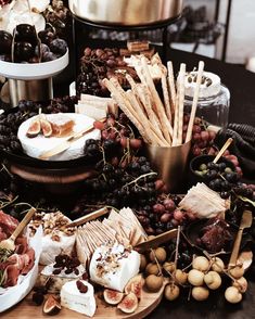 a table topped with lots of different types of cheese and crackers on top of it