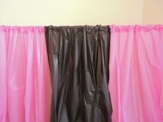 pink and black curtains are hanging on the wall