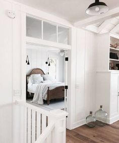 a bedroom with white walls and wood floors is seen in this image from the inside