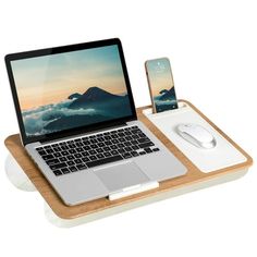 an open laptop computer sitting on top of a wooden tray next to a mouse and cell phone