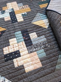 a close up of a quilt on a bed