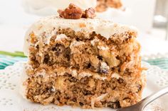 a close up of a piece of cake on a plate with a fork in front of it