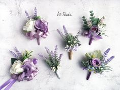 purple and white boutions are arranged on a table with the word it's bride written in cursive writing