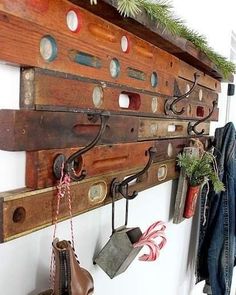 a wooden coat rack with many different items hanging from it's sides and on the wall